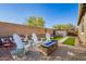 Charming backyard with a fire pit and lounge chairs, perfect for outdoor relaxation and entertaining at 32096 N 132Nd Dr, Peoria, AZ 85383