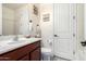 Clean bathroom featuring a vanity with sink, toilet, white door, and neutral paint at 32096 N 132Nd Dr, Peoria, AZ 85383