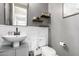Elegant powder room featuring a vanity, toilet, modern fixtures, and decorative wall accents at 32096 N 132Nd Dr, Peoria, AZ 85383