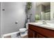 Stylish bathroom with wood look flooring, vanity with gray walls and modern fixtures at 32096 N 132Nd Dr, Peoria, AZ 85383
