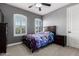 Bright bedroom featuring stylish decor, a ceiling fan, and shuttered windows for natural light at 32096 N 132Nd Dr, Peoria, AZ 85383