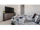 Cozy bedroom features a dresser with a television and stylish patterned bedding at 32096 N 132Nd Dr, Peoria, AZ 85383