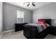 Cozy bedroom with neutral walls, carpet flooring, ceiling fan and shuttered windows at 32096 N 132Nd Dr, Peoria, AZ 85383