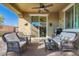 Cozy covered patio with wicker furniture, creating a relaxing outdoor living space for gatherings and relaxation at 32096 N 132Nd Dr, Peoria, AZ 85383