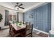 Traditional dining room with rustic wood table, stylish ceiling fan, and wainscoting at 32096 N 132Nd Dr, Peoria, AZ 85383