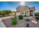 Beautiful home exterior with a well-manicured front yard, desert landscaping, and an inviting facade at 32096 N 132Nd Dr, Peoria, AZ 85383
