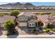 Beautiful two-story home with a red tile roof, a two-car garage, and a professionally landscaped front yard at 32096 N 132Nd Dr, Peoria, AZ 85383