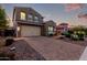 Welcoming two-story home boasting a paver driveway and beautiful landscaping at 32096 N 132Nd Dr, Peoria, AZ 85383