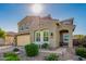Inviting exterior of a home with desert landscaping, a covered entryway, and an attached two-car garage at 32096 N 132Nd Dr, Peoria, AZ 85383