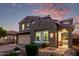 Inviting two-story home offering a charming entrance, paver driveway, and beautifully manicured landscaping at 32096 N 132Nd Dr, Peoria, AZ 85383