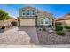 Handsome two-story home with a two-car garage, paver driveway, and neatly landscaped front yard at 32096 N 132Nd Dr, Peoria, AZ 85383