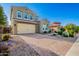 Lovely two-story home showcasing a paver driveway and well-maintained landscaping at 32096 N 132Nd Dr, Peoria, AZ 85383