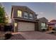 Elegant two-story home with a paver driveway and meticulously landscaped front yard at 32096 N 132Nd Dr, Peoria, AZ 85383