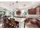Bright kitchen featuring a large island with seating, stainless steel appliances, and ample cabinet space at 32096 N 132Nd Dr, Peoria, AZ 85383