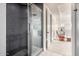 Modern tiled shower with glass enclosure in the main bathroom adjacent to the main bedroom at 32096 N 132Nd Dr, Peoria, AZ 85383