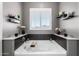 Close-up of the relaxing tub in the main bathroom featuring elegant tiling and decor at 32096 N 132Nd Dr, Peoria, AZ 85383