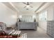 Spacious main bedroom featuring tray ceilings, ceiling fan and shuttered windows for abundant natural light at 32096 N 132Nd Dr, Peoria, AZ 85383