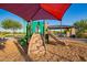 A shaded playground with slides and climbing structures offers fun for families at 32096 N 132Nd Dr, Peoria, AZ 85383