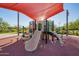A shaded playground with slides and climbing structures offers fun for families at 32096 N 132Nd Dr, Peoria, AZ 85383