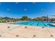 A community pool with lounge chairs and shade structures offers a relaxing outdoor experience at 32096 N 132Nd Dr, Peoria, AZ 85383