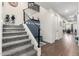 Carpeted staircase featuring modern railings and a custom-built storage bench, leading to the upper level at 32096 N 132Nd Dr, Peoria, AZ 85383