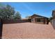 Large backyard with gravel surface and block fencing, offering privacy and space at 3545 W Glass Ln, Phoenix, AZ 85041
