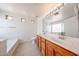 Bathroom features a double sink vanity, bathtub, and ample lighting for a bright and welcoming space at 3545 W Glass Ln, Phoenix, AZ 85041