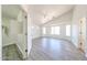 Spacious bedroom features wood-look flooring, a ceiling fan, and ample natural light from multiple windows at 3545 W Glass Ln, Phoenix, AZ 85041