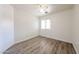 A well-lit bedroom with neutral walls, wood-look floors, and a ceiling fan for added comfort at 3545 W Glass Ln, Phoenix, AZ 85041