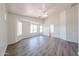 Large bedroom features wood-look flooring, ceiling fan, and windows that provide plenty of natural light at 3545 W Glass Ln, Phoenix, AZ 85041