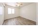 Cozy bedroom with ample natural light and wood-look flooring, ideal for a peaceful night's rest at 3545 W Glass Ln, Phoenix, AZ 85041