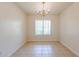 Bright dining room area featuring neutral paint, tile flooring, and a chandelier fixture at 3545 W Glass Ln, Phoenix, AZ 85041