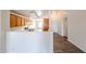 Bright kitchen featuring wooden cabinetry, laminate countertops, wood look flooring, and track lighting at 3545 W Glass Ln, Phoenix, AZ 85041