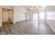 Open-concept living area with neutral walls and wood-look flooring, providing a versatile living space at 3545 W Glass Ln, Phoenix, AZ 85041