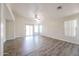 Spacious living room with ample natural light and wood-look flooring, ideal for relaxing and entertaining at 3545 W Glass Ln, Phoenix, AZ 85041