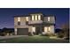 Inviting two-story home with a well-maintained lawn and an attached two-car garage at 35501 N Tin Ct, San Tan Valley, AZ 85144