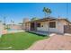 Exterior view of backyard with covered patio, small grassy area, and access to a shared community pool at 3620 S Terrace Rd, Tempe, AZ 85282