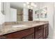 Bathroom features a granite countertop with double sinks, storage, and neutral-tile shower at 3620 S Terrace Rd, Tempe, AZ 85282