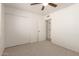 Bright bedroom with closet, ceiling fan, carpet, and access to an adjacent room at 3620 S Terrace Rd, Tempe, AZ 85282