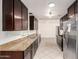 Kitchen with stainless steel appliances, granite countertops, and dark wood cabinets at 3620 S Terrace Rd, Tempe, AZ 85282