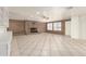 Large living room featuring a brick fireplace, tile flooring, recessed lighting, and white shelving at 3620 S Terrace Rd, Tempe, AZ 85282