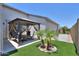 Green backyard featuring artificial turf, desert landscaping, and a shaded gazebo with seating at 38144 W San Clemente St, Maricopa, AZ 85138