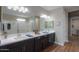 Bathroom featuring double sinks, large mirrors, and a spacious walk-in shower at 38144 W San Clemente St, Maricopa, AZ 85138