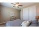 Bedroom with carpet, ceiling fan and closet, with neutral colored walls at 38144 W San Clemente St, Maricopa, AZ 85138