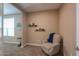 Cozy bedroom nook with plush chair, reading space, and neutral decor at 38144 W San Clemente St, Maricopa, AZ 85138