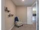 Bedroom nook featuring an armchair, soft carpet, and calming neutral tones at 38144 W San Clemente St, Maricopa, AZ 85138