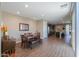 Open-concept dining area leading to a kitchen and outdoor space, with modern lighting and wood-look tile flooring at 38144 W San Clemente St, Maricopa, AZ 85138