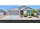 Charming single-story home showcasing a well-manicured front yard, a two-car garage, and desert landscaping at 38144 W San Clemente St, Maricopa, AZ 85138