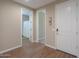 Hallway with tile flooring and neutral walls, with access to bathroom and other rooms at 38144 W San Clemente St, Maricopa, AZ 85138