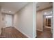 Hallway with tile flooring leads to entry door and an infrared sauna room at 38144 W San Clemente St, Maricopa, AZ 85138
